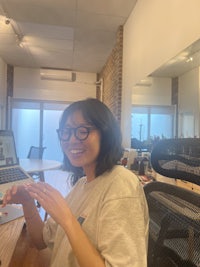 a woman sitting at a desk with a laptop