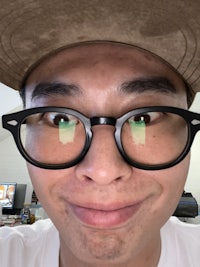 a man wearing glasses and a hat